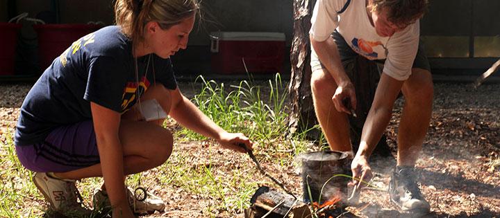 Students starting a campfire 